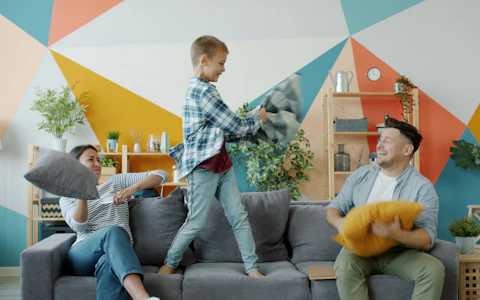 Familia jugando en el sofá de su casa